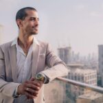 male, model, portrait, man, face, male model, black shirt, smile, smiling, smiling man, modeling, pose, posing, studio photography, male portrait, guy, business, building, office, businessman, thinking, bitcoin, crypto, jewelry