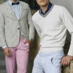 Two men in stylish clothing pose outdoors showcasing modern fashion trends.